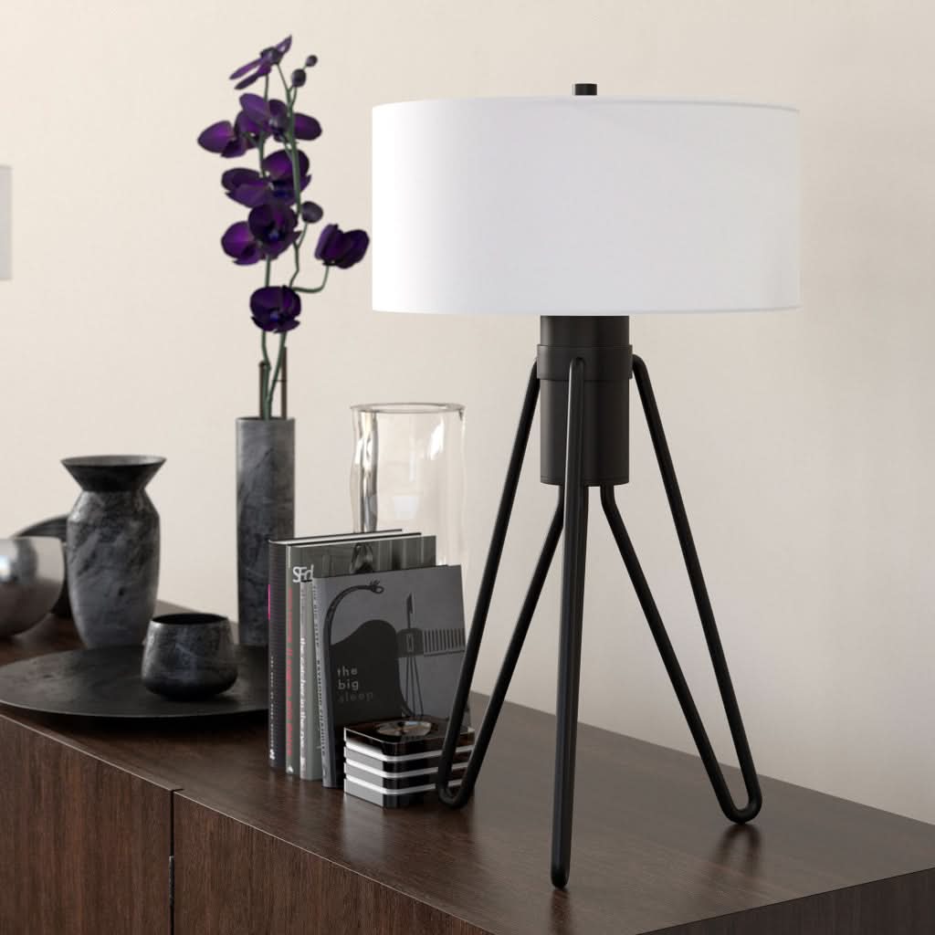 Mid Century Table Lamp Brass Tripod with white shade and black metal tripod base on dark wood table.